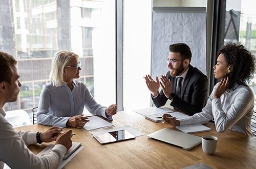Affärsmöte där deltagare diskuterar villkor och prissättning